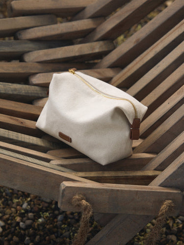 Songmont canvas storage bag with leather accent and gold zipper