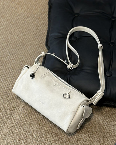 Mini Yore Camera Bag in cloud white vegetable-tanned leather with silver hardware and ebony wood zipper pull.