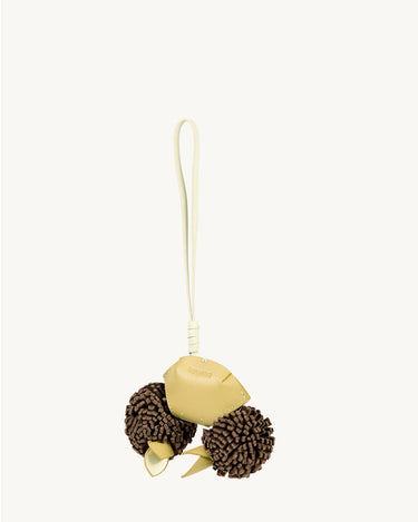 Light yellow leather crab charm with brown pom-poms and leaf accents