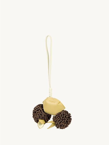Light yellow leather crab charm with brown pom-poms and leaf accents