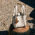 Songmont Puppy Charm: Textured cream leather tote bag with dog silhouette charm