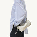 Mini Yore Camera Bag in cloud color made from vegetable-tanned leather with silver hardware.