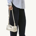 Mini Yore Camera Bag in Cloud color, crafted from vegetable-tanned leather with unique tiger-tooth buckle detail.