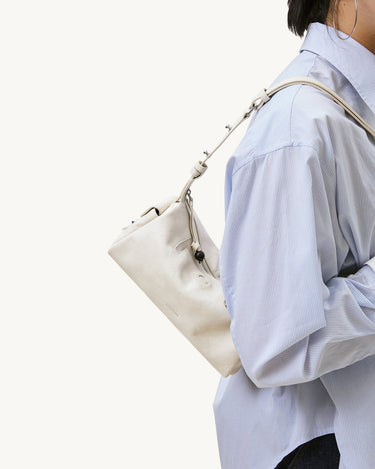 Mini Yore Camera Bag in Cloud, made from vegetable-tanned leather with adjustable strap.