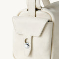 Mini Yore Camera Bag in Cloud color, crafted from vegetable-tanned leather with a classic flap and button closure.