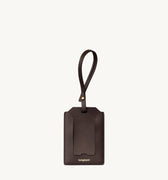 Brown leather Songmont luggage tag with strap and clear card slot.