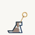 Songmont Puppy Charm: Multicolor leather keychain shaped like a playful dog with gold-tone ring.