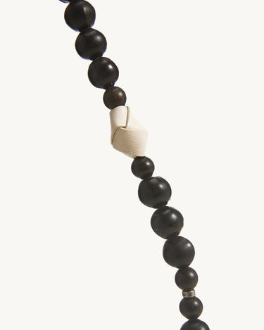Large Carefree Thread Charm in Sandal color, featuring alternating dark wooden beads and a cream leather knot detail.