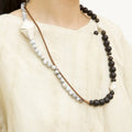 Large Carefree Thread Charm necklace: sandalwood, light stone beads, white leather diamond charm.