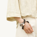 Large Carefree Thread Charm bracelet with sandalwood and marbled beads, featuring a leather diamond charm.