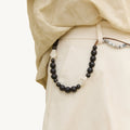 Large Carefree Thread Charm Sandal: dark beads, leather diamonds, seed beads on trousers.
