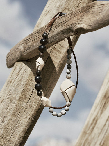 Small Carefree Thread Charm in Sandal with dark wood, stone, and leather charms