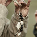 Small Carefree Thread Charm in Sandal color with wooden and leather beads.