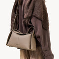Drippy Roof Bag in Cobble textured leather with adjustable strap, worn crossbody.
