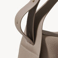 Drippy Roof Bag in Cobble: Textured taupe leather tote with detailed stitching and gold hardware accent.