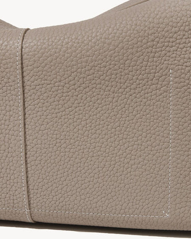 Drippy Roof Bag in Cobble textured leather, featuring detailed stitching and pocket. Premium leather tote for women.