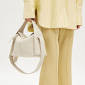 Drippy Roof Bag in cream full-grain leather with adjustable strap and SS hardware.