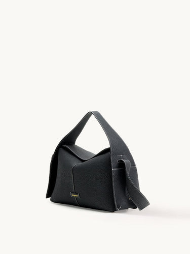 Black full-grain leather Drippy Roof Bag with flap closure and white stitching. Features gold "Songmont" logo.