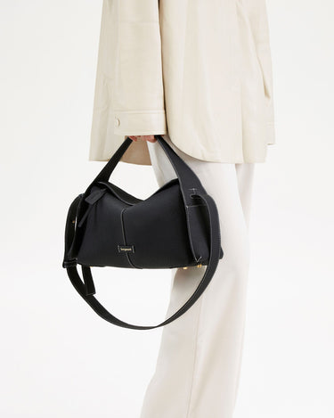 Black pebbled leather Drippy Roof Bag with white stitching, adjustable strap, and 'Songmont' logo