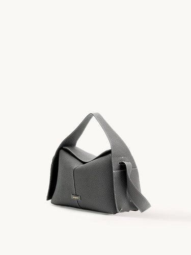 Textured charcoal grey leather Drippy Roof Bag with white stitching and golden Songmont logo.
