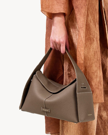 Taupe leather Drippy Roof Bag with pebbled texture and white stitching, a luxury shoulder bag.