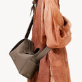Taupe Drippy Roof Bag by Songmont, textured full-grain leather tote with architectural design. Adjustable strap for crossbody/shoulder wear.