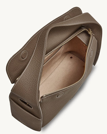 Taupe leather Drippy Roof Bag with an open main compartment and interior pocket.