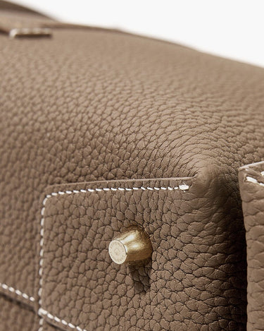Taupe full-grain leather Drippy Roof Bag with contrast stitching and embossed Songmont brass hardware.