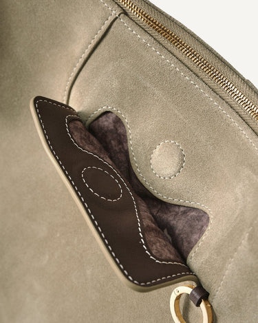 Extra Large Yore Hobo Bag in Dune Suede, with leather trim pocket, white stitching, and gold zipper.