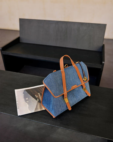 Denim Faith Stone Charm bag with brown leather straps, gold hardware, and 'Songmont' logo.