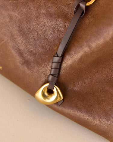 Faith Stone Charm bag accessory in brown leather with gold charm and leather tie