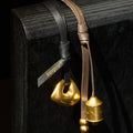 Faith Stone Charm & Prayer Wheel Charm Set in Sandal and Onyx colors, featuring gold-toned pendants.