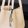 Faith Stone & Prayer Wheel Charm Set: Sandal textured leather tote with gold hardware charm detail.