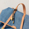 Songmont Sandal denim bag with tan leather straps and gold hardware