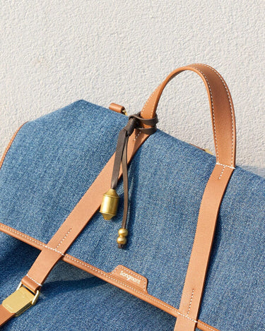 Songmont Sandal denim bag with tan leather straps and gold hardware