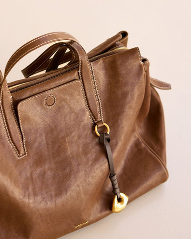 Faith Stone Charm & Prayer Wheel Charm Set in Sandal color, vegetable-tanned leather with gold hardware.