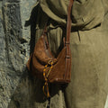 Brown suede Freedom Cord shoulder bag with leather strap and yellow tassel detail.