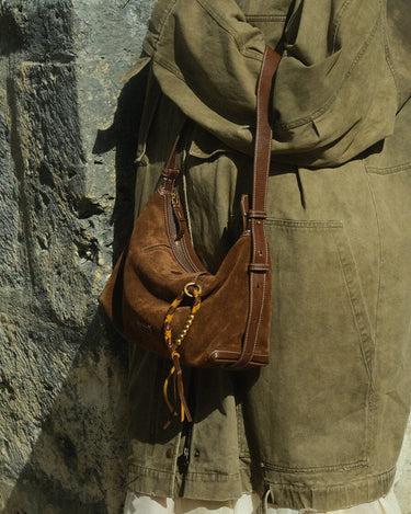 Brown suede Freedom Cord shoulder bag with leather strap and yellow tassel detail.