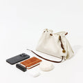 Cloud Gather Clutch Set with iPhone, power bank, earbuds, and compact