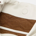Interior of white Gather Clutch Set with quilted brown lining and magnetic snap closure.