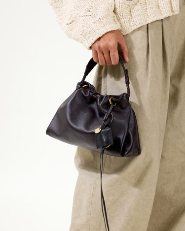 Ebony Gather Clutch Set in full-grain nappa leather with braided handle and gold hardware.