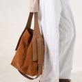 Large Drippy Tote Bag in Caramel: A spacious suede tote with leather straps and side pockets, perfect for everyday use.