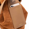 Caramel suede Large Drippy Tote Bag with leather phone pocket holding a smartphone. Gold Songmont logo.