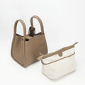 Large taupe Song bag with cream canvas pouch, full-grain leather, magnetic closure.