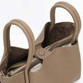 Taupe large Song bag with textured full-grain leather, magnetic closure, and interior zippered pouch.
