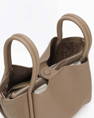 Taupe large Song bag with textured full-grain leather, magnetic closure, and interior zippered pouch.
