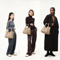 Large Song Bag in taupe pebbled leather, shown on models of varying heights (160cm, 170cm, 178cm).