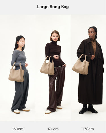 Large Song Bag in taupe pebbled leather, shown on models of varying heights (160cm, 170cm, 178cm).