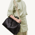 Black Yore bowling bag in full-grain Nappa leather, white stitching, SS 304 hardware, patterned strap.