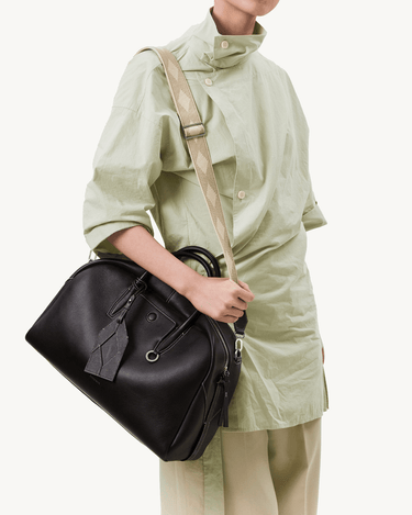 Black Yore bowling bag in full-grain Nappa leather, white stitching, SS 304 hardware, patterned strap.